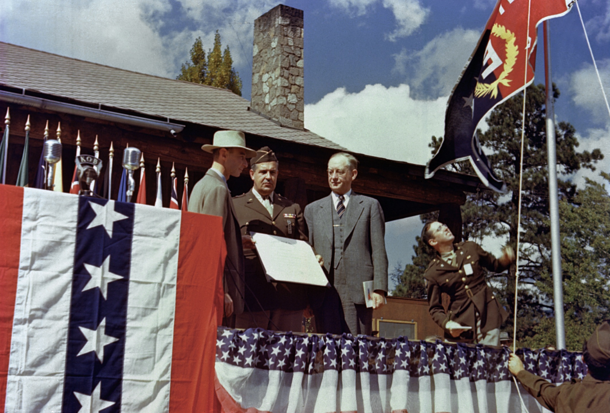 Los Alamos ranch house. Robert Oppenheimer, Leslie Groves and Robert Sproul at the ceremony to present the Los Alamos Laboratory with the Army-Navy E Award.
